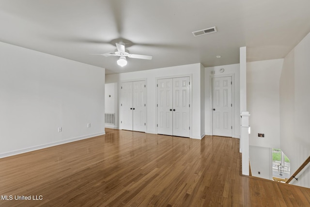 13 Highland Meadows Dr, Jackson, MS 39211 - unfurnished bedroom with multiple closets, wood finished floors, and a ceiling fan