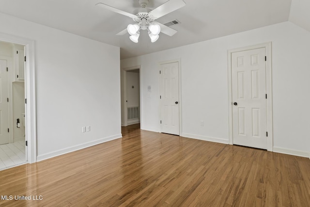13 Highland Meadows Dr, Jackson, MS 39211 - unfurnished bedroom featuring wood finished floors, connected bathroom, and two closets