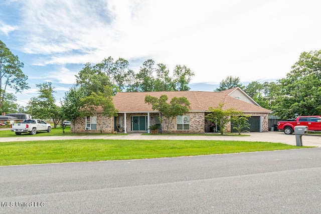 6492 Kalipekona Way, Diamondhead, MS 39525 - ranch-style home featuring a front lawn, an attached garage, driveway, and brick siding