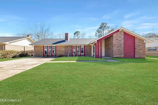 2167 Baywood Dr, Biloxi, MS 39532 - view of front facade with driveway, a chimney, a front lawn, and brick siding