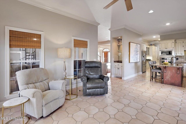 living room with crown molding, recessed lighting, baseboards, and ceiling fan