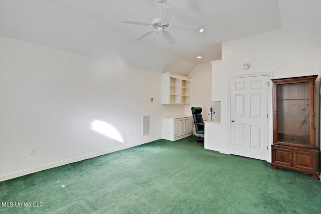 interior space featuring carpet, baseboards, visible vents, lofted ceiling, and ceiling fan