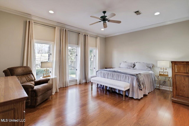 bedroom with visible vents, crown molding, recessed lighting, wood finished floors, and a ceiling fan