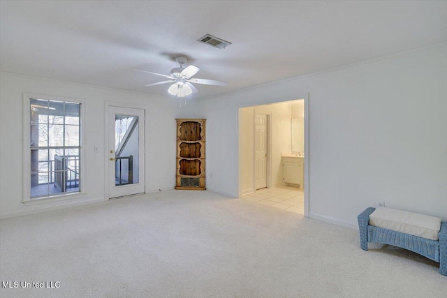 unfurnished bedroom with baseboards, visible vents, ensuite bathroom, light carpet, and crown molding