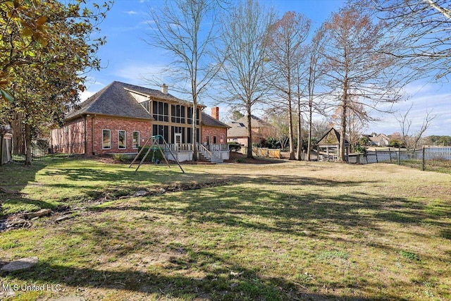 view of yard with a fenced backyard and a sunroom