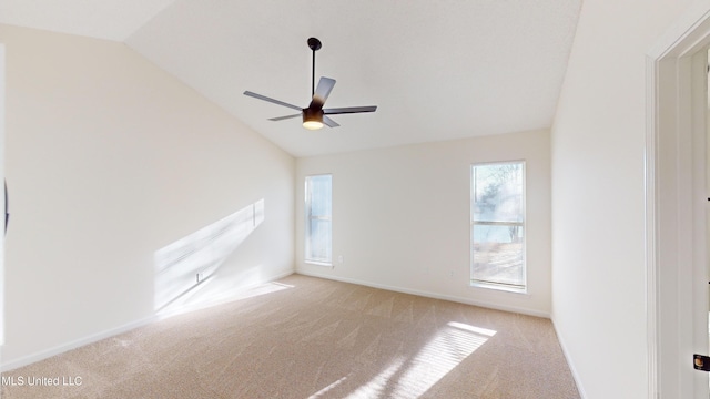 unfurnished room with vaulted ceiling, light colored carpet, and ceiling fan