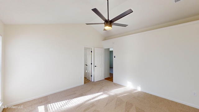 unfurnished room with ceiling fan, light colored carpet, and vaulted ceiling