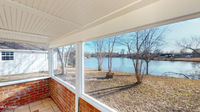 sunroom / solarium with a water view and beam ceiling