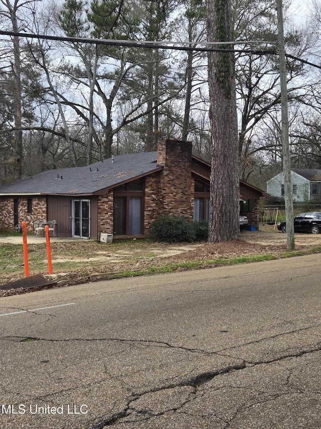 view of front of home featuring a chimney