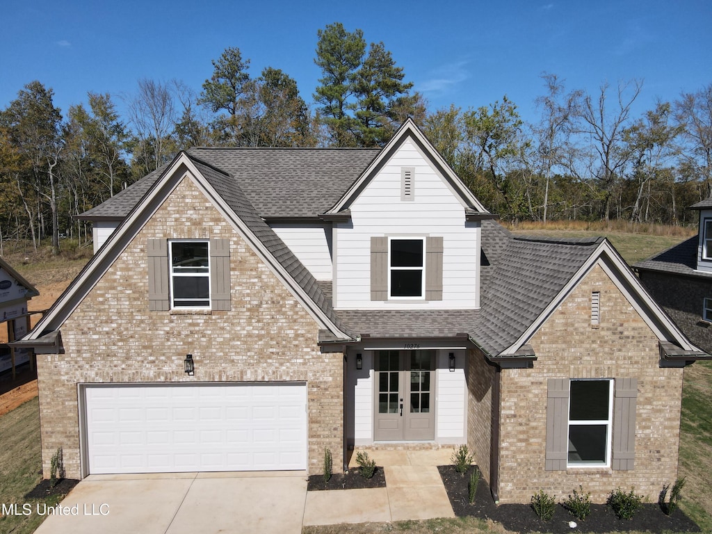 117 Centerline Roper Loop, Byhalia, MS 38611 - view of front facade with brick siding, a shingled roof, and concrete driveway