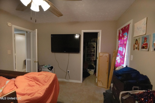 bedroom featuring light colored carpet and ceiling fan