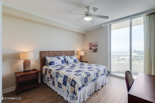 2060 Beach Blvd Unit 1602, Biloxi, MS 39531 - bedroom with wood finished floors, access to outside, expansive windows, ceiling fan, and baseboards