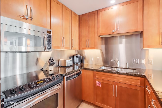 2060 Beach Blvd Unit 1602, Biloxi, MS 39531 - kitchen with stainless steel appliances, a sink, dark stone counters, and brown cabinetry