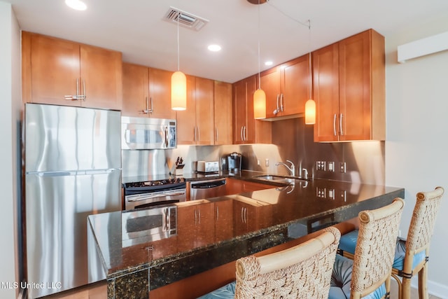 2060 Beach Blvd Unit 1602, Biloxi, MS 39531 - kitchen featuring appliances with stainless steel finishes, a sink, recessed lighting, hanging light fixtures, and dark stone countertops