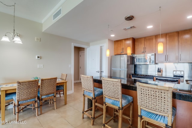 2060 Beach Blvd Unit 1602, Biloxi, MS 39531 - kitchen with appliances with stainless steel finishes, a chandelier, light tile patterned flooring, decorative light fixtures, and recessed lighting