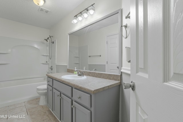 bathroom with vanity, visible vents, tile patterned flooring, a textured ceiling, and toilet