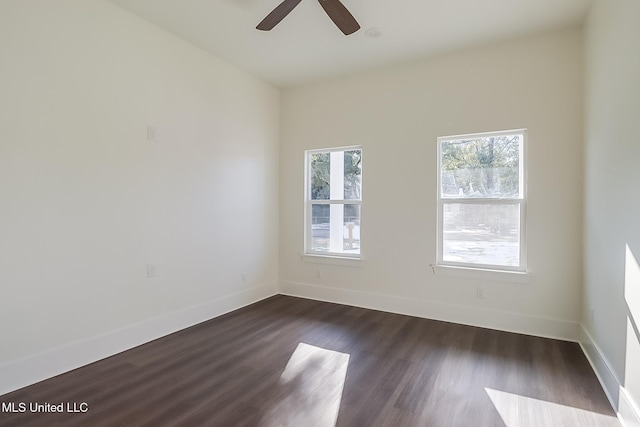 spare room with dark wood-type flooring and ceiling fan