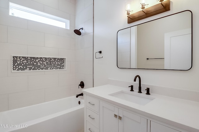 bathroom with tiled shower / bath and vanity