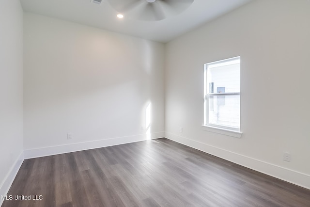 spare room featuring dark hardwood / wood-style floors and ceiling fan