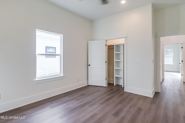 unfurnished bedroom featuring dark wood-type flooring and a closet