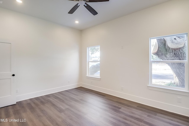 empty room featuring dark wood-type flooring and ceiling fan