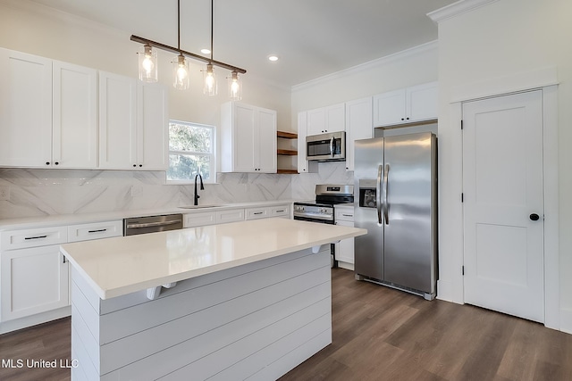 kitchen featuring a kitchen island, decorative light fixtures, white cabinetry, backsplash, and stainless steel appliances