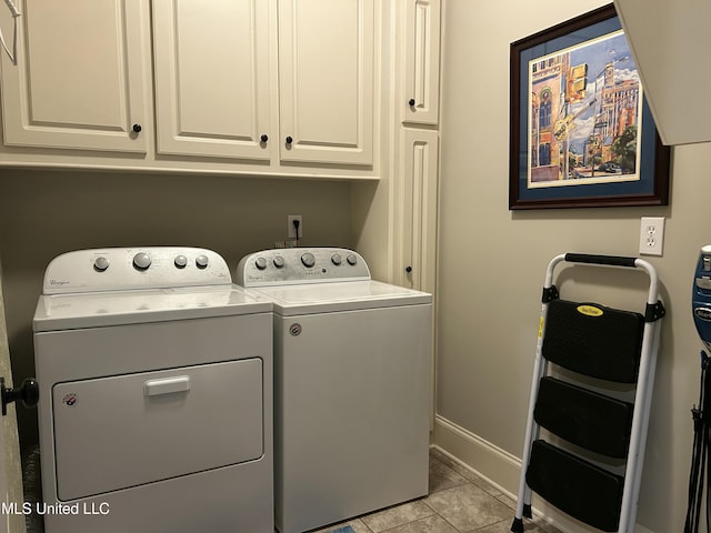 153 Bradfield Rd, Gluckstadt, MS 39110 - washroom featuring separate washer and dryer, cabinet space, baseboards, and light tile patterned flooring