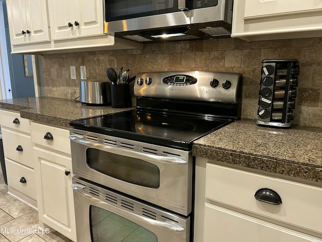 153 Bradfield Rd, Gluckstadt, MS 39110 - kitchen with appliances with stainless steel finishes, light tile patterned floors, white cabinetry, and decorative backsplash