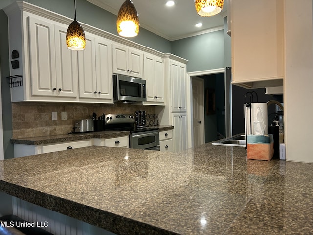 153 Bradfield Rd, Gluckstadt, MS 39110 - kitchen featuring stainless steel appliances, white cabinetry, crown molding, backsplash, and recessed lighting