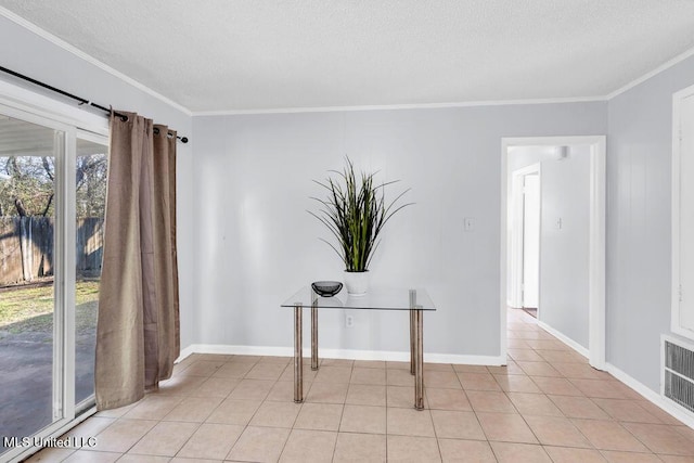 interior space with ornamental molding, light tile patterned flooring, visible vents, and baseboards