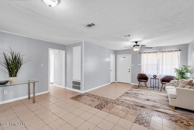 entrance foyer with visible vents, a textured ceiling, and light tile patterned floors