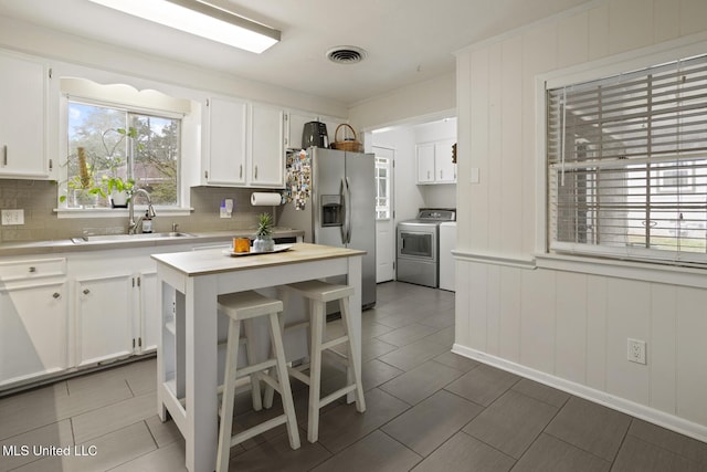 kitchen with stainless steel fridge with ice dispenser, sink, tasteful backsplash, and white cabinets