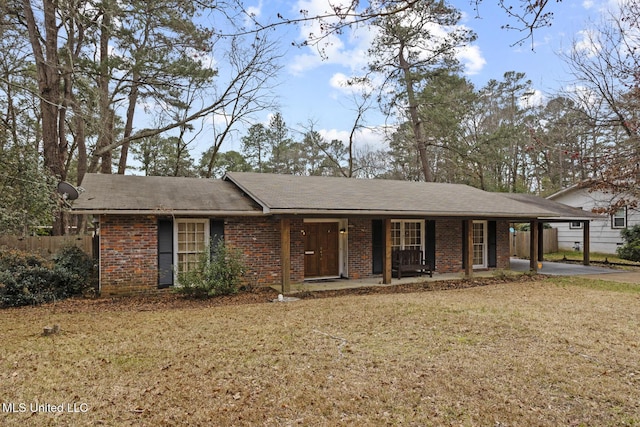 single story home with a front lawn, a carport, and a porch