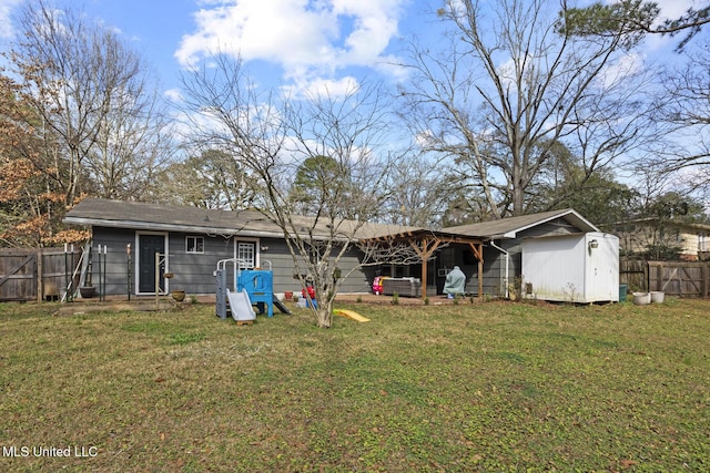 rear view of property featuring a yard