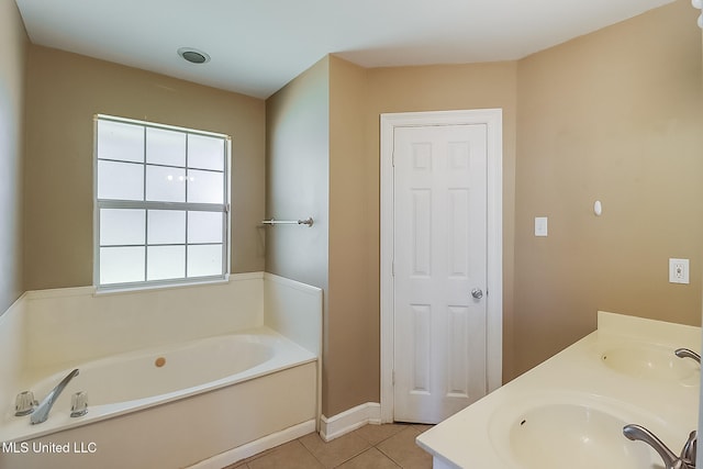 bathroom featuring tile patterned floors, a tub, and vanity