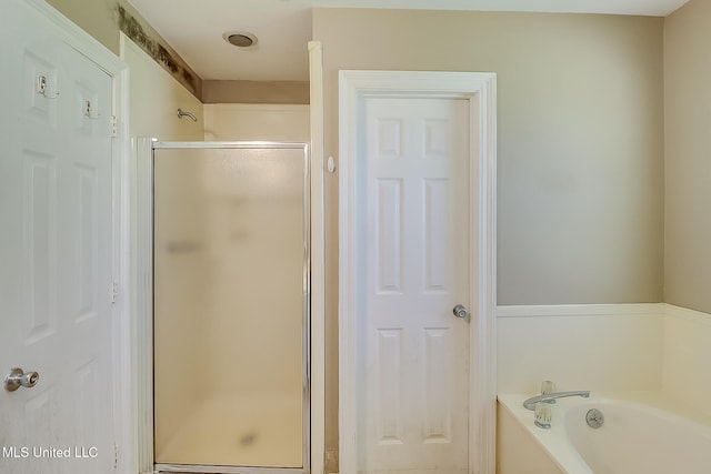 bathroom with shower with separate bathtub