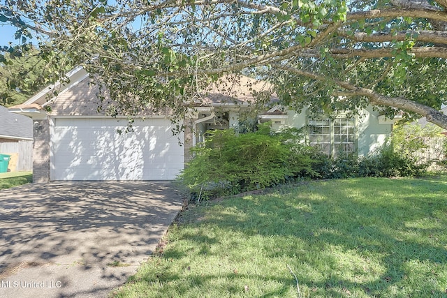 view of front of home with a garage and a front lawn