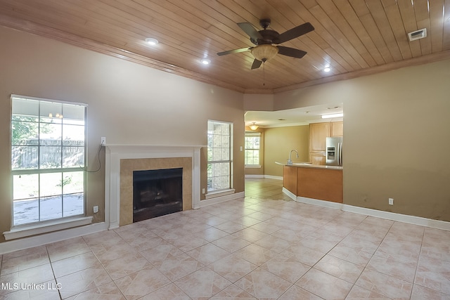 unfurnished living room with ornamental molding, wood ceiling, ceiling fan, a fireplace, and light tile patterned flooring