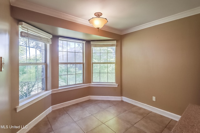 spare room with light tile patterned floors and crown molding