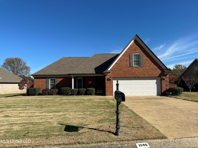 view of front of house with a front yard and a garage