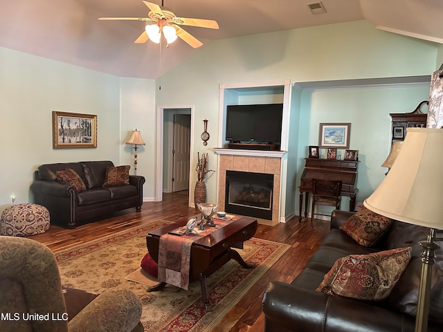 living room with a tile fireplace, ceiling fan, dark hardwood / wood-style flooring, and lofted ceiling