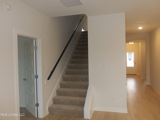 stairway featuring wood-type flooring