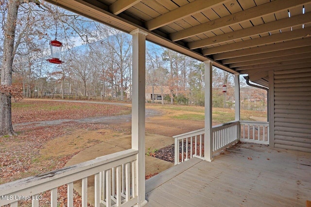 wooden terrace featuring covered porch