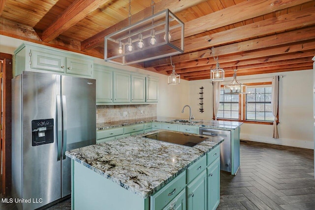 kitchen with kitchen peninsula, a kitchen island, decorative light fixtures, and appliances with stainless steel finishes