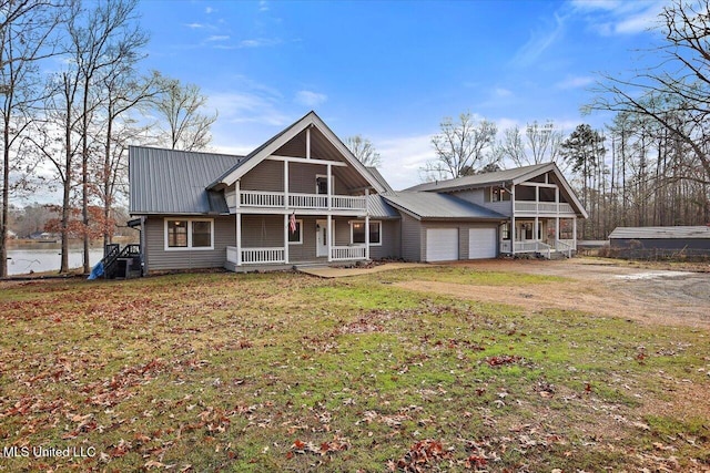 view of front of house with covered porch, a sunroom, a garage, and a front yard