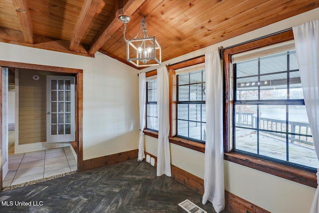 interior space with a chandelier, vaulted ceiling with beams, a healthy amount of sunlight, and wooden ceiling