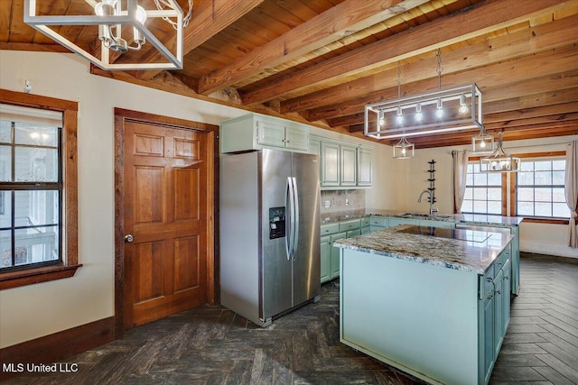 kitchen featuring wooden ceiling, hanging light fixtures, stainless steel fridge, beam ceiling, and kitchen peninsula