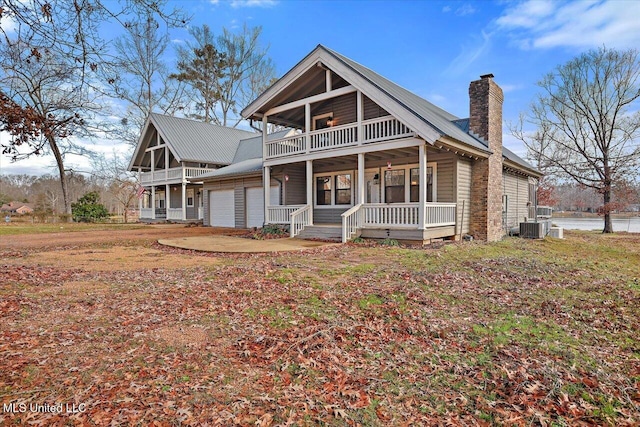 view of front of house with a garage, covered porch, and cooling unit