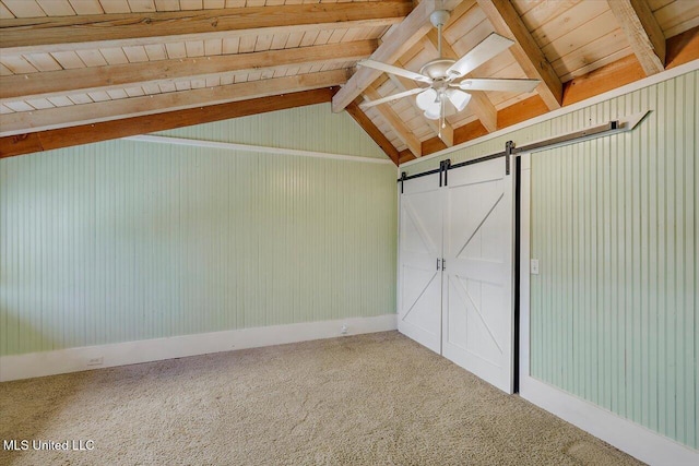 unfurnished bedroom with a barn door, carpet floors, wood ceiling, and vaulted ceiling with beams