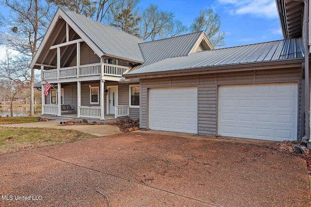 view of front of home with covered porch and a garage